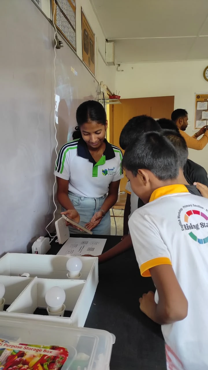 A NEST member helping students with a school workshop activity