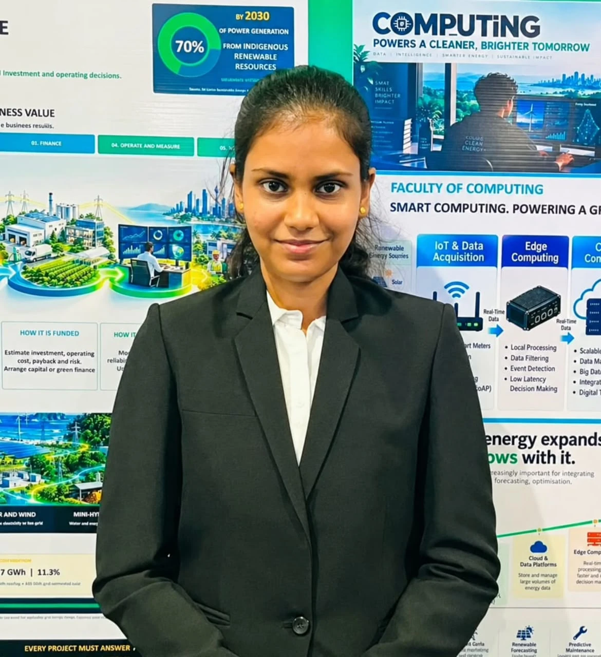 A club member beside the computing and renewable energy billboards