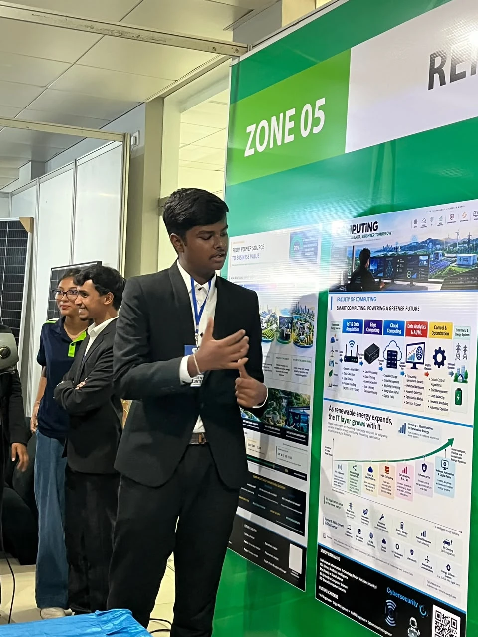 A NEST member beside the computing and renewable energy displays at Open Day
